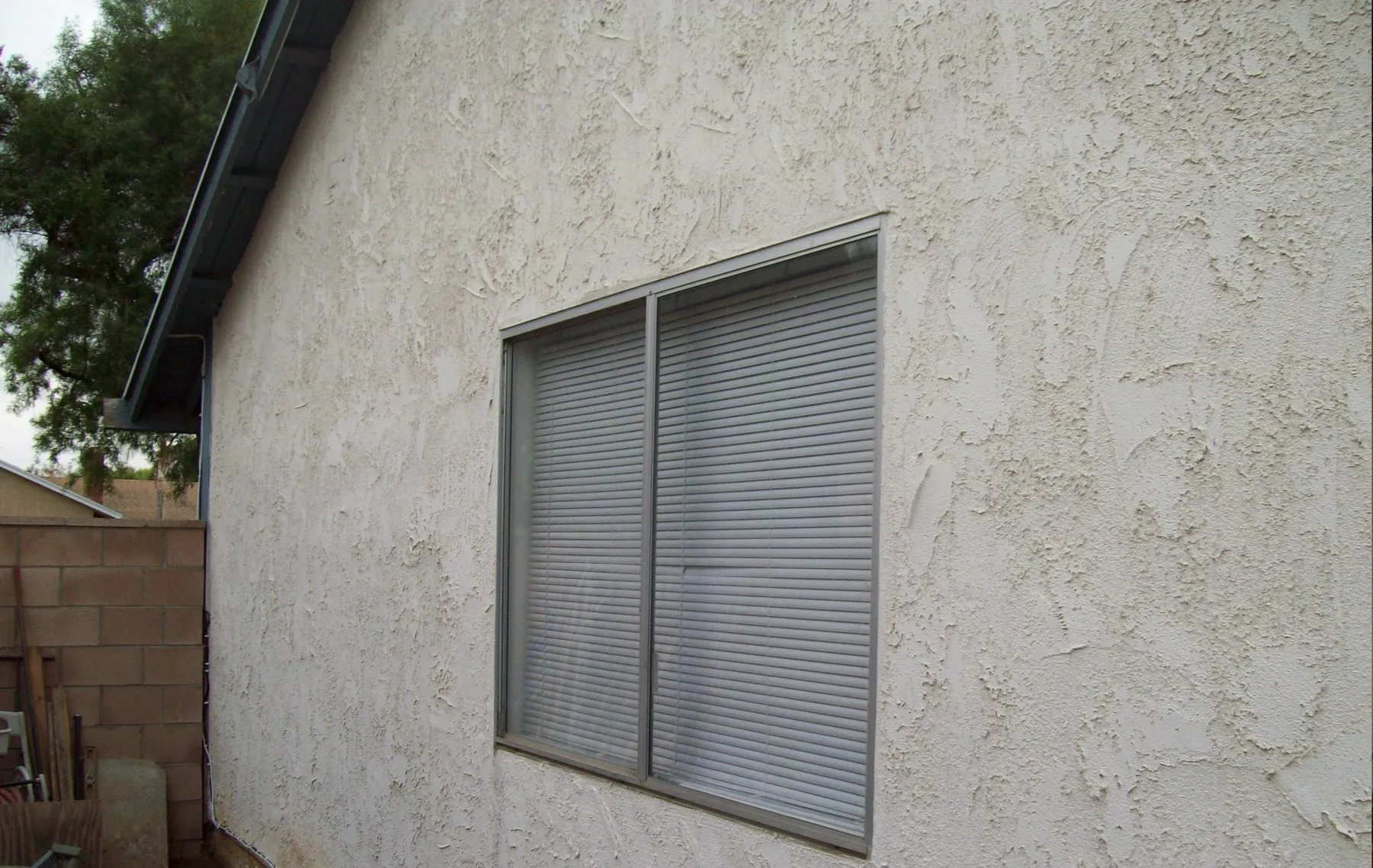 Before: a side-yard corner window before and after replacement