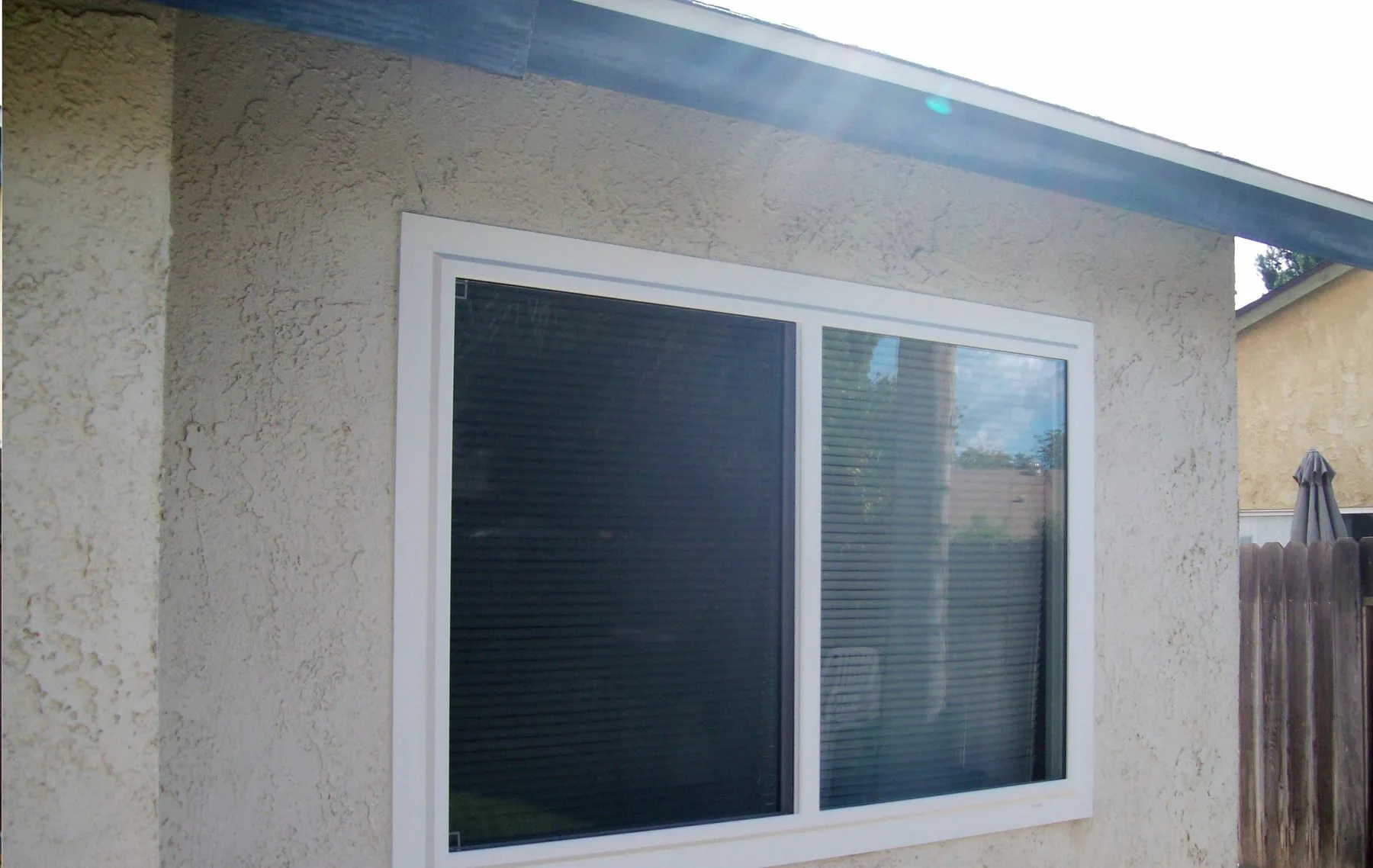 After: a single window swapped for a white vinyl replacement