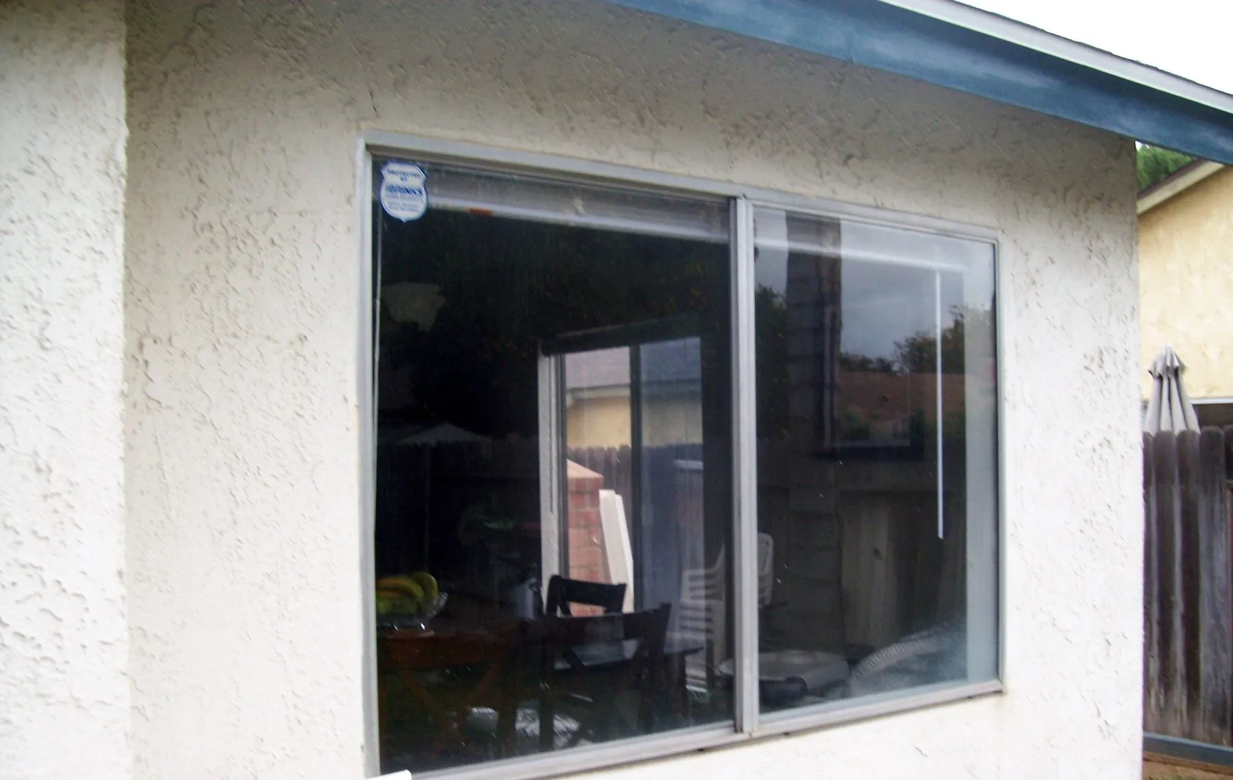 Before: a single window swapped for a white vinyl replacement