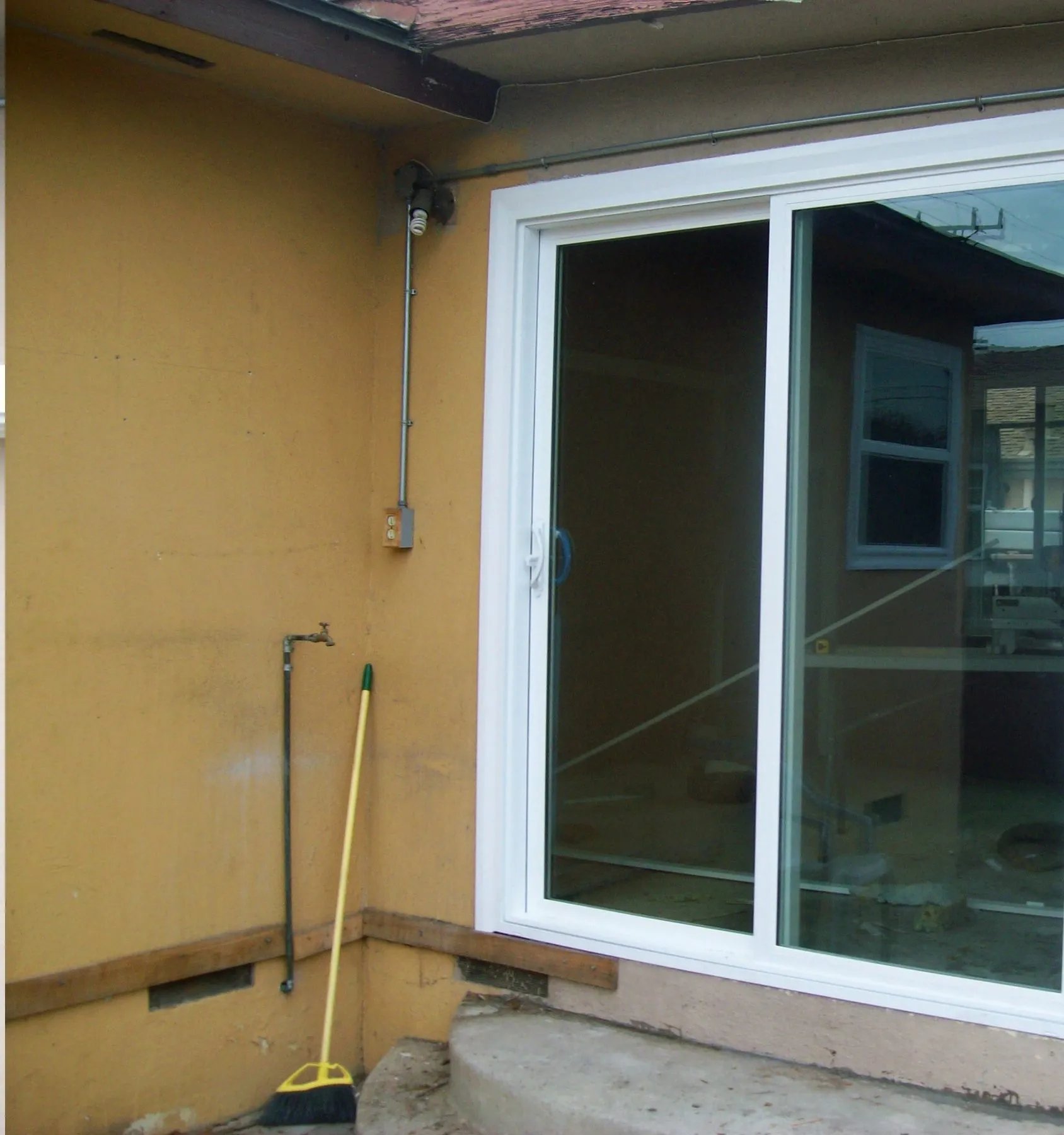 The same opening with a new white vinyl sliding glass door fitted