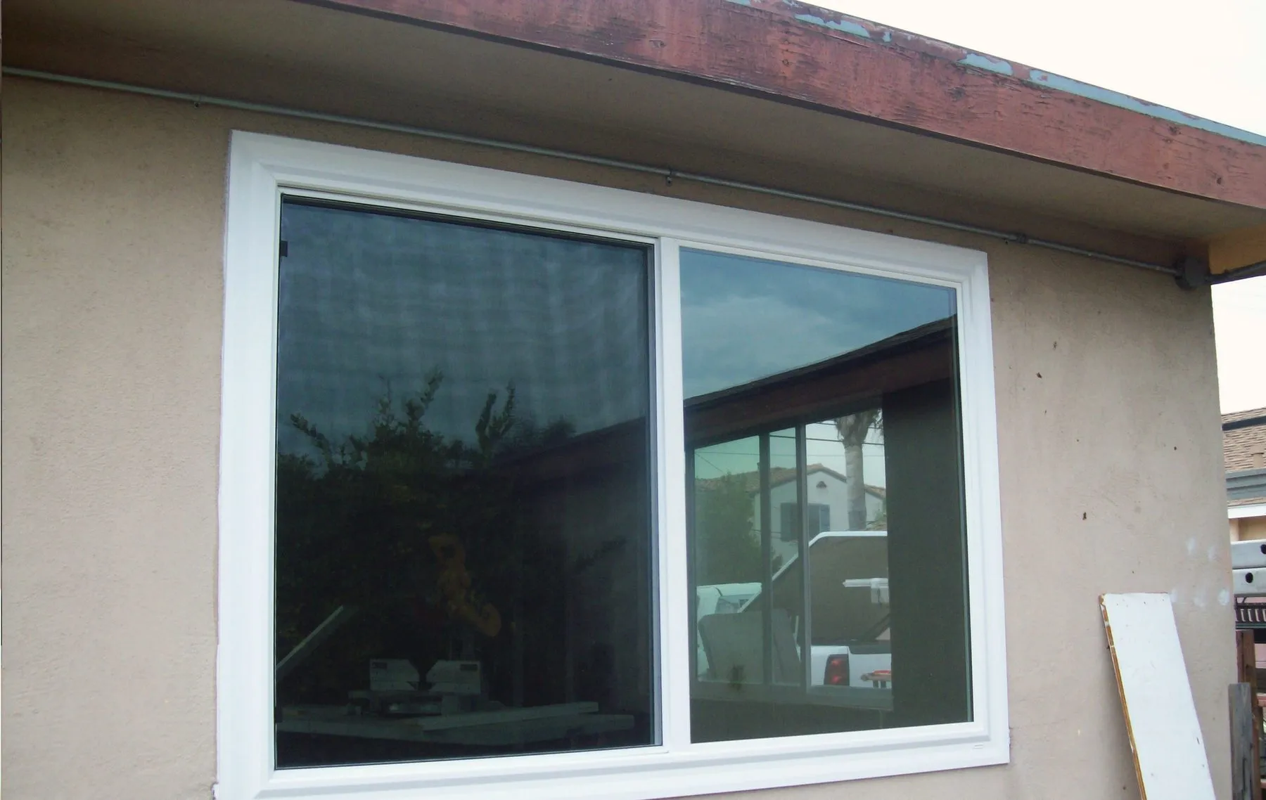 The same corner of the house with new white windows fitted