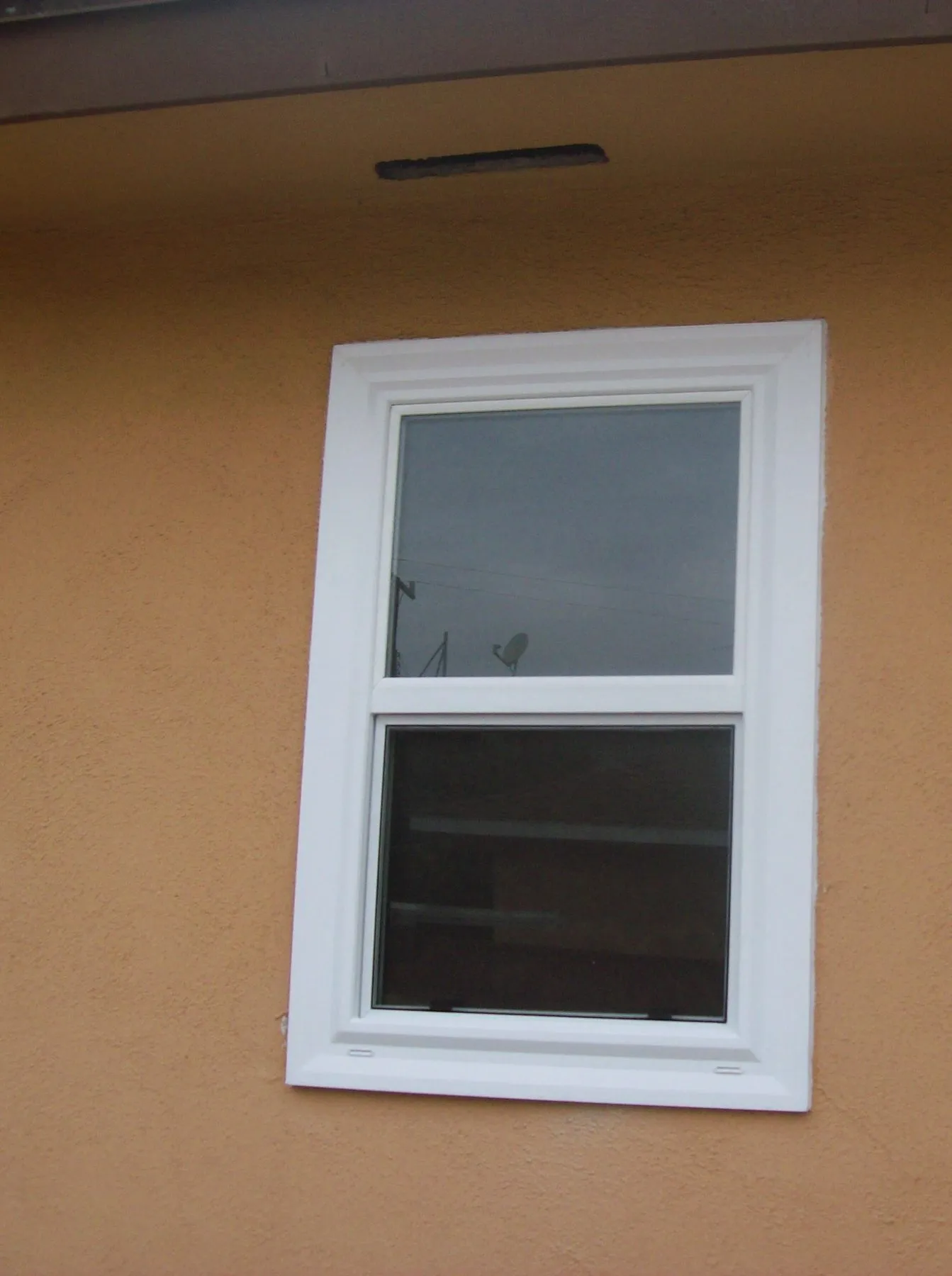 After: a pair of front windows before and after replacement