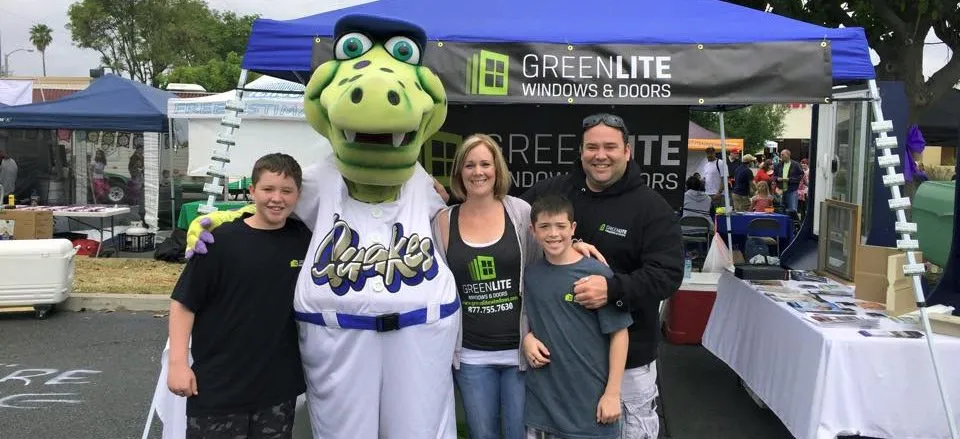 A Green Lite Windows and Doors booth at an outdoor community event