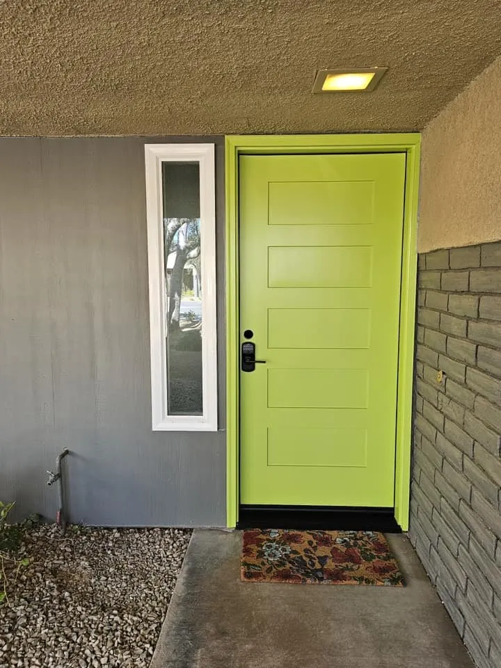 A finished painted entry door with new hardware fitted