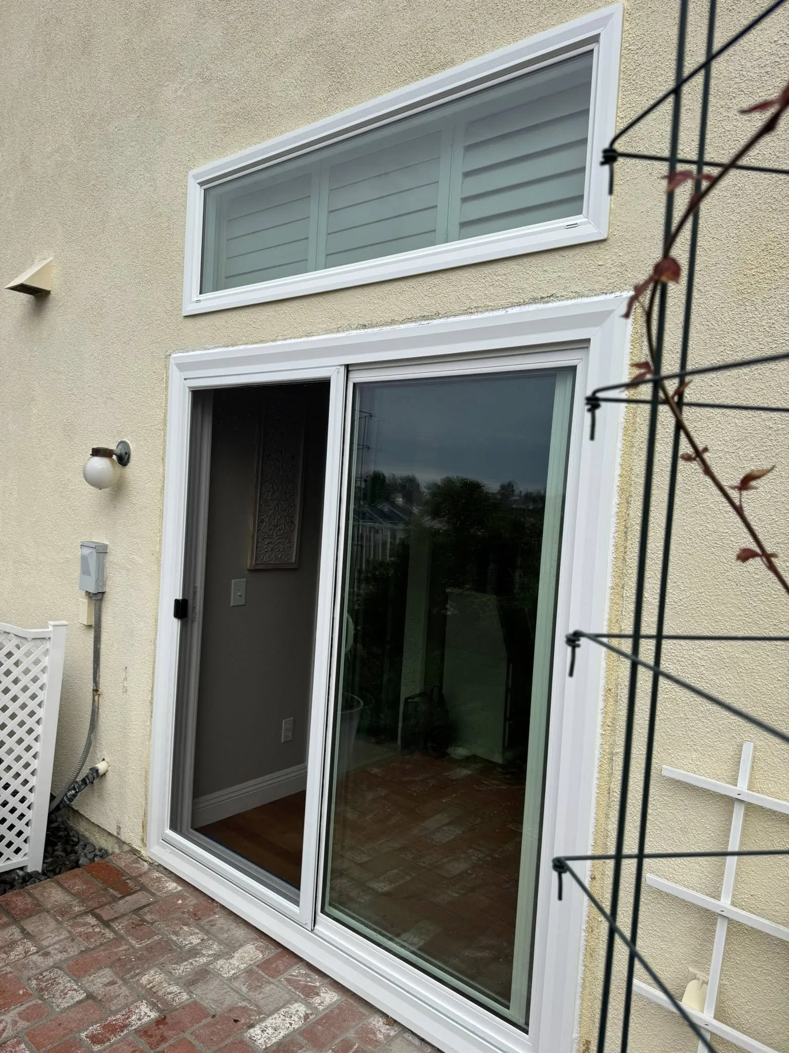 A finished white vinyl sliding patio door seen from inside
